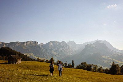 Two people hiking in the mountains near Appenzell