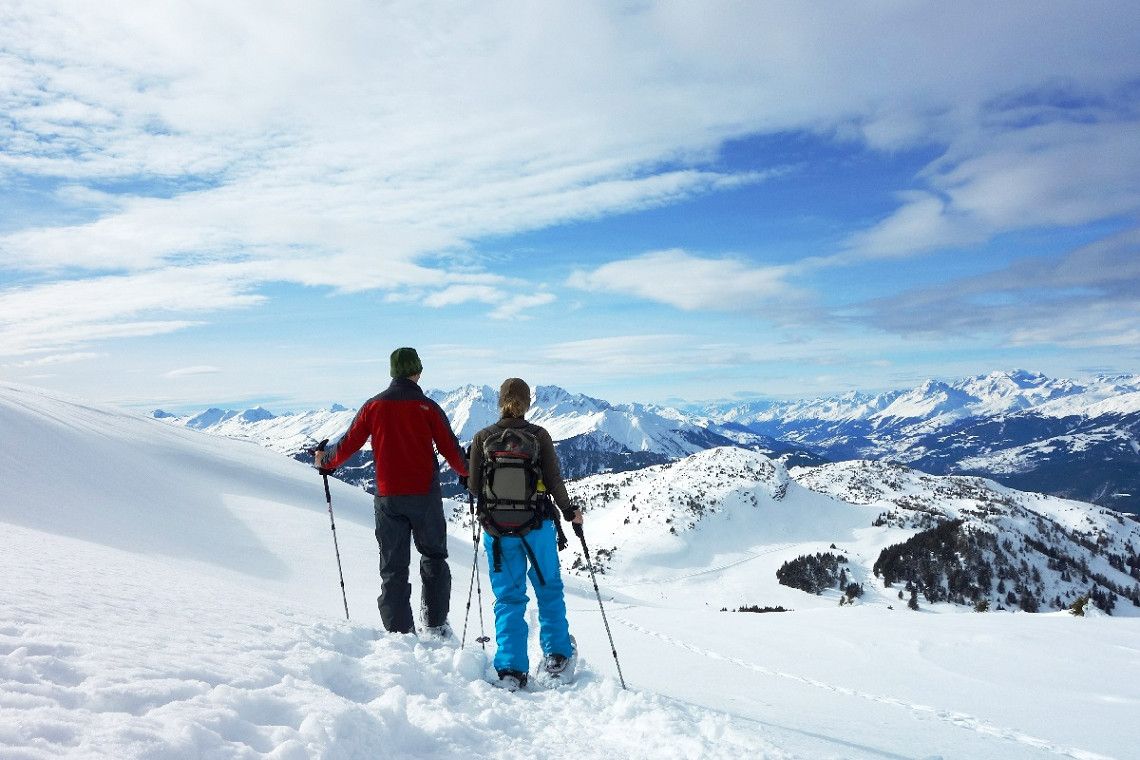 Snowshoe hikers on the Dreibündenstein plateau in winter