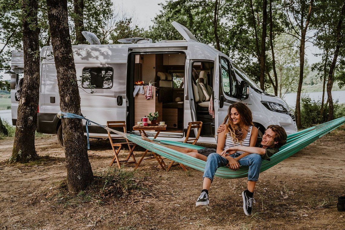 Laika Kosmo campervan on a pitch with a couple in a hammock