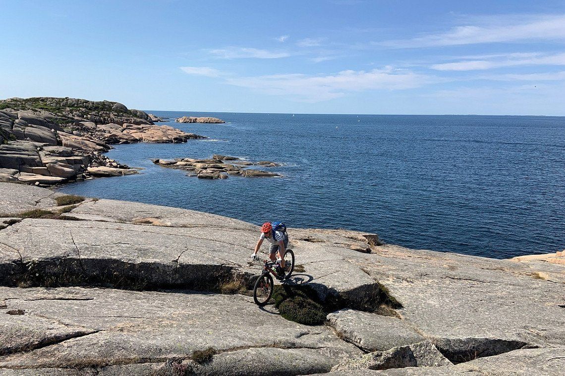 Mountain biking over rocks on the Ramsvik Peninsula