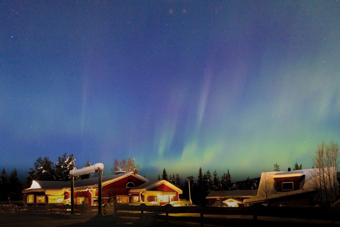 Aurora borealis above an illuminated hotel