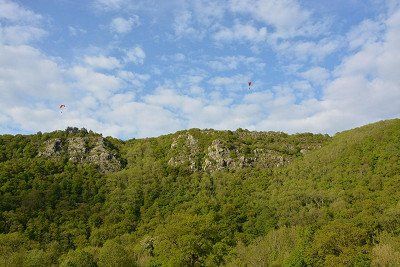 Forest, rocks and paragliders in Norman Switzerland