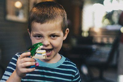 Child with dino toy