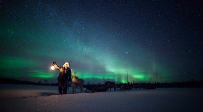 Reindeir sleigh in front of the aurora borealis