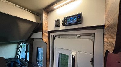 Truma Bedienpanel CP plus und Control Panel von CBE ueber der Tuer des Laika Wohnmobils Ecovip H 2109
