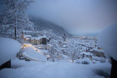 Chur surrounded by mountains in the clouds in winter