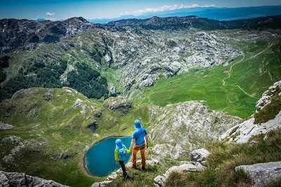 An adult and child hiking in the Morača mountain range, Montenegro