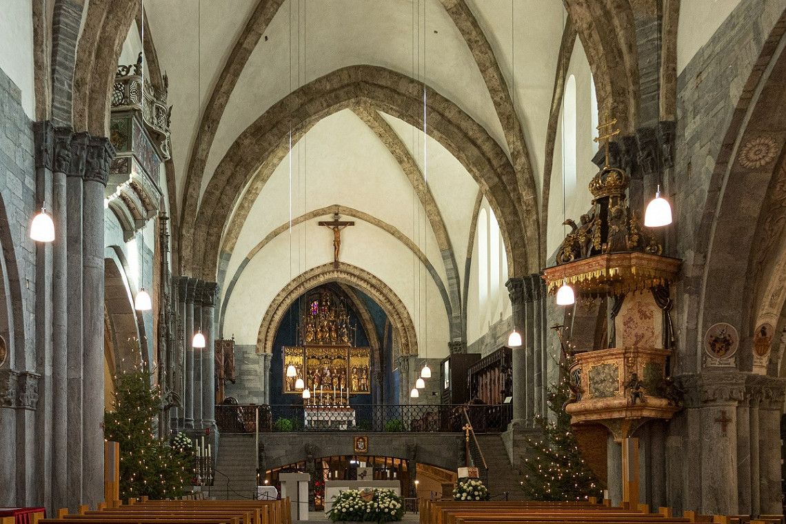 The inside of Chur Cathedral with a golden high altar