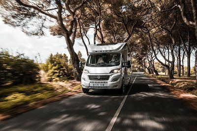 Laika motorhome Kosmo on an Italian country road with daytime running lights