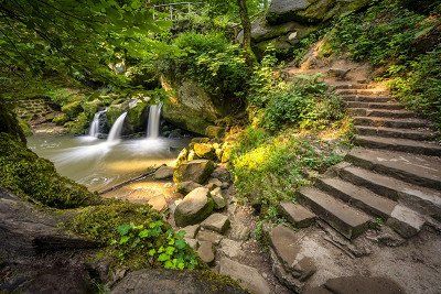 Historical bridge over the Schiessentümpel waterfall in the Mullerthal region