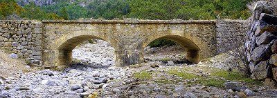 old stonebridge over dried-up riverbed in Spain