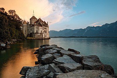 Chillon Castle on a lake at nightfall