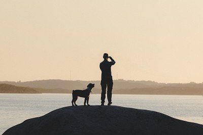 Woman and a dog on an island in Bohuslän in Sweden