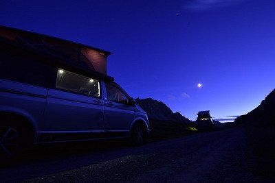 zwei Urbancamper mit Aufstelldach nachts in den Bergen