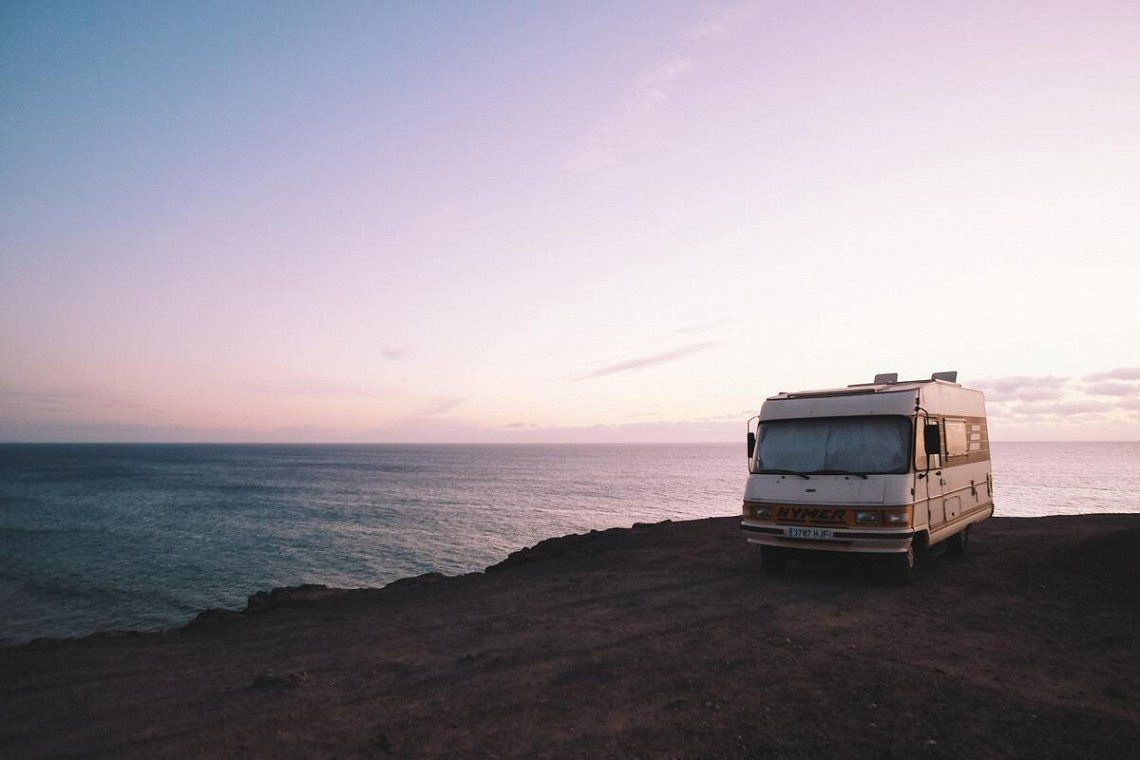 Hymer motorhome on the Mediterranean coast in Spain at sunset