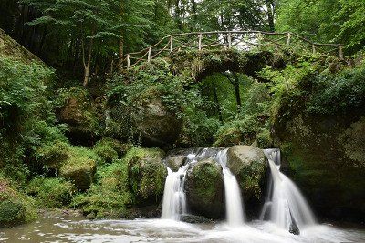 Historical bridge over the Schiessentümpel waterfall in the Mullerthal region