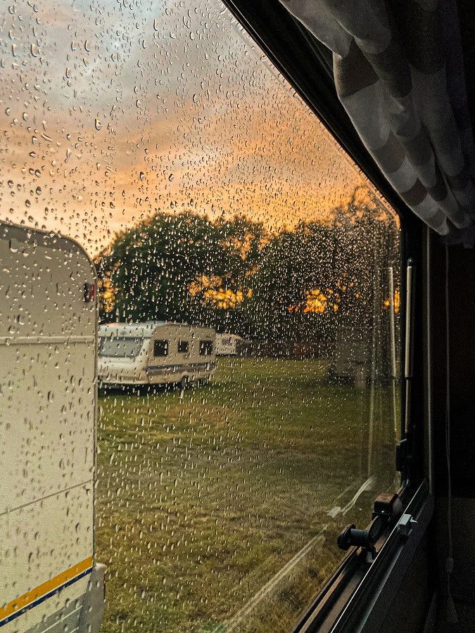 View of a caravan from a camper window during rain